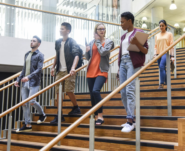 College students walking down staris.