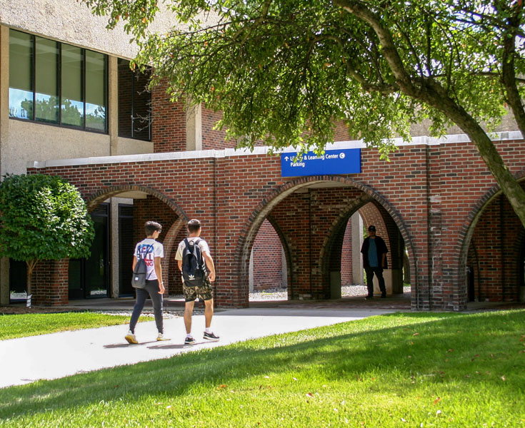 Two students walking on center campus.