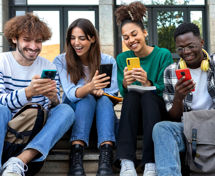 Students talking and looking at their cell phones.