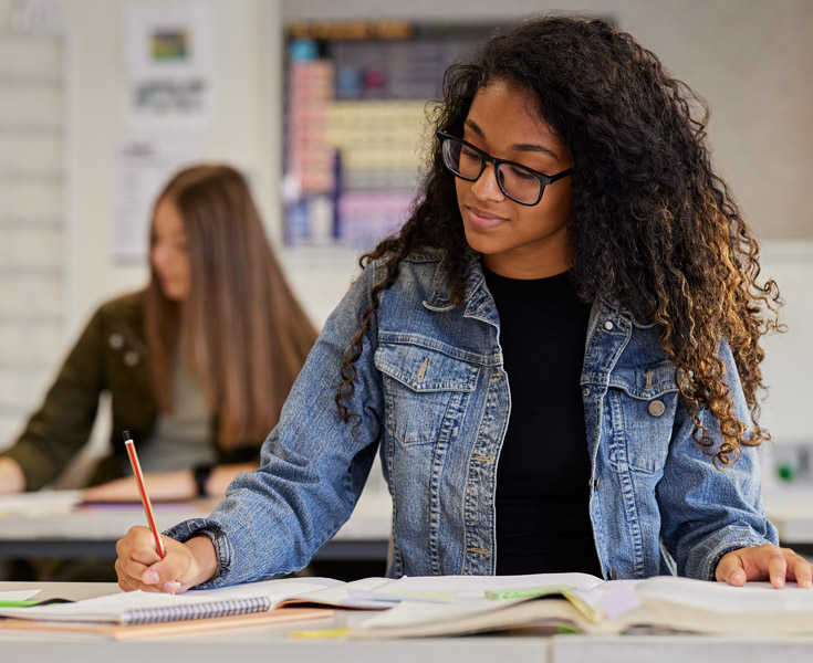 A student taking a test in a classroom.