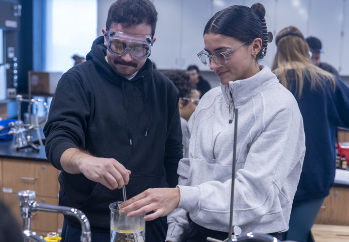 Student in science class working with professor