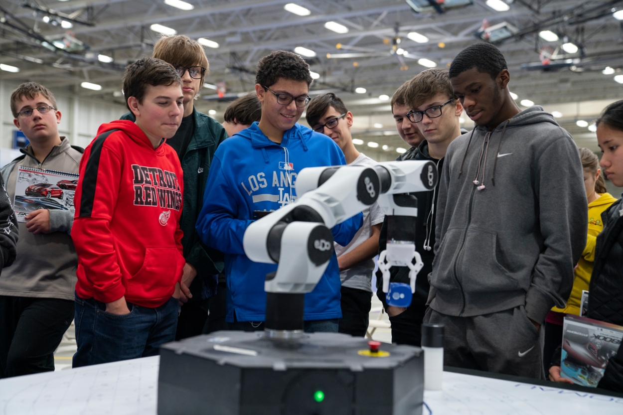 Attendees can explore interactive displays including robotics