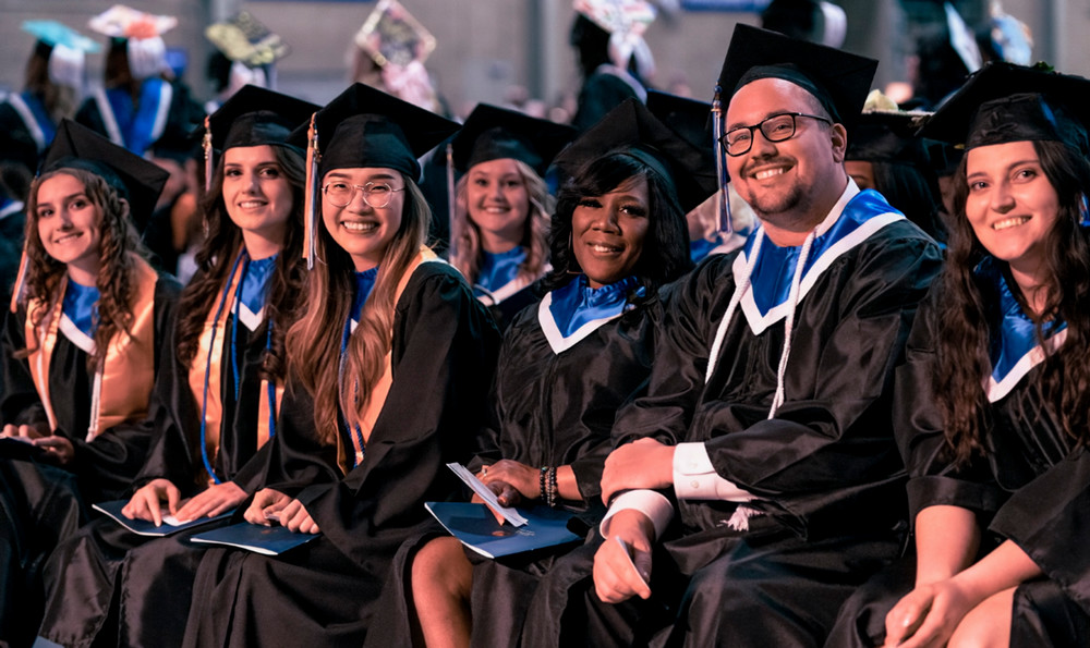 Macomb Community College graduates from winter semester 2023 anxiously await their turn to walk across the stage.