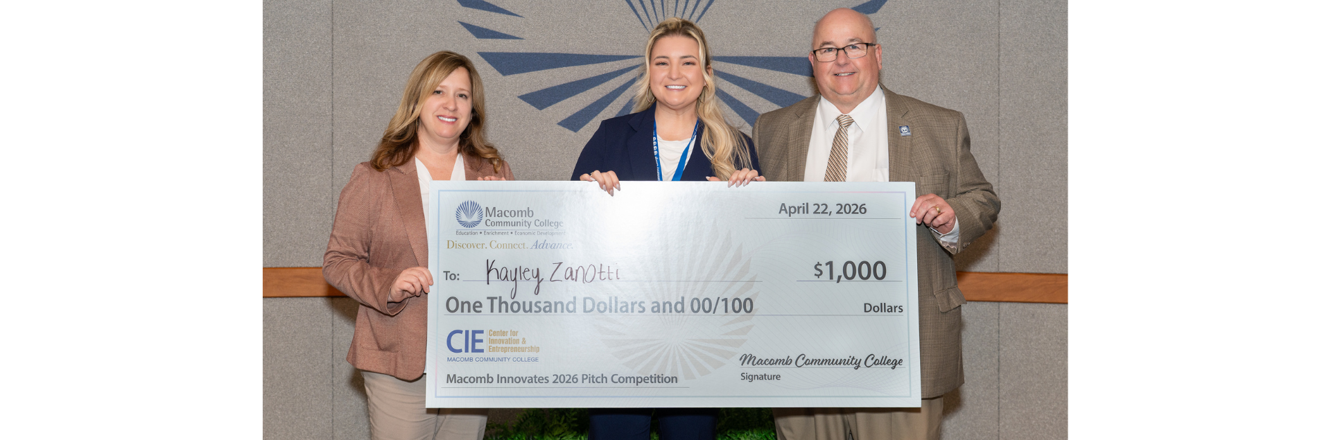 From left to right:  Diane Banks, director, Macomb Community College Foundation; Kayley Zanotti, Macomb Community College student; and Macomb President James O. Sawyer IV during the presentation of the $1,000 prize Zanotti received for winning the college division of Macomb Innovates: The Next Big Thing pitch competition. 